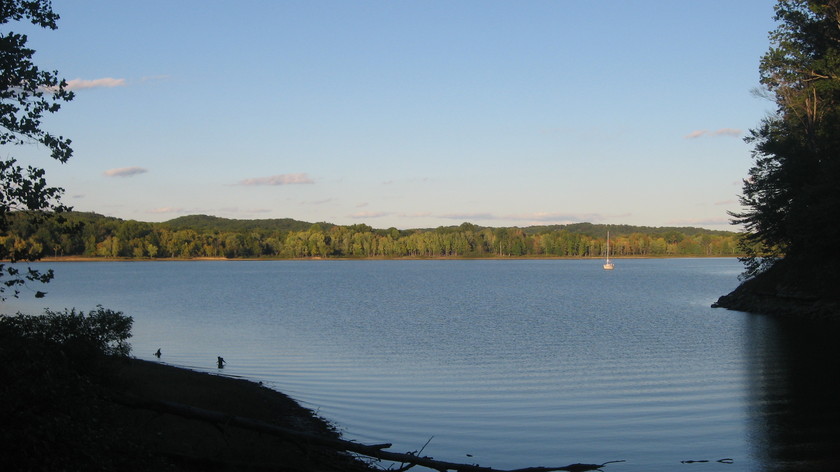 Calm Lake Monroe view with sailboat and tree line