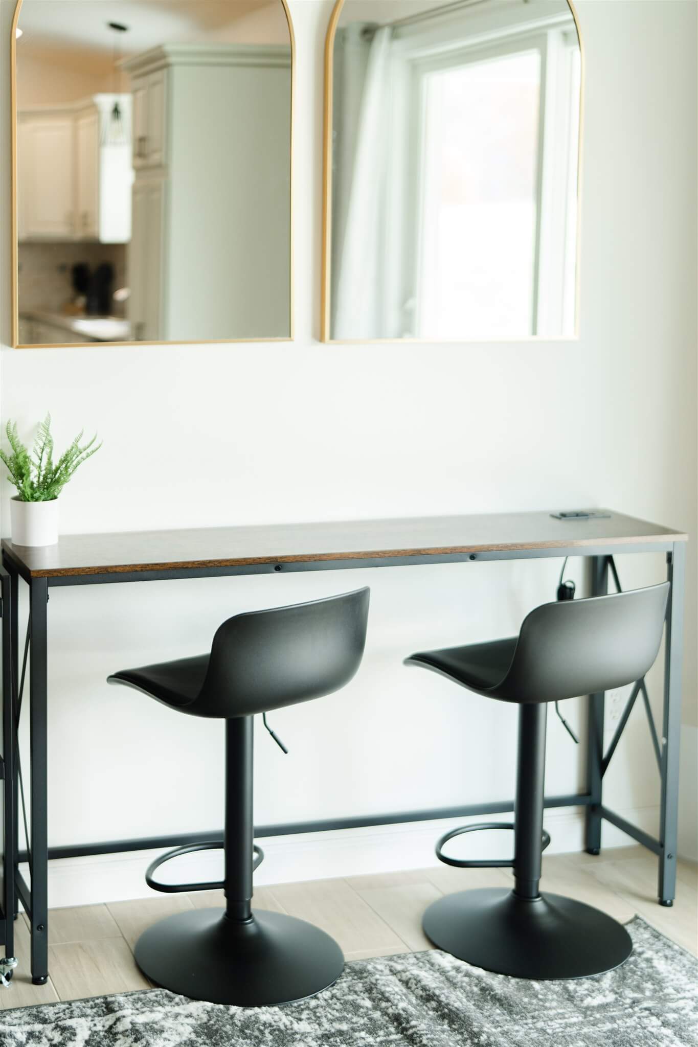 Pair of Glam Suite beauty chairs beneath arched mirrors