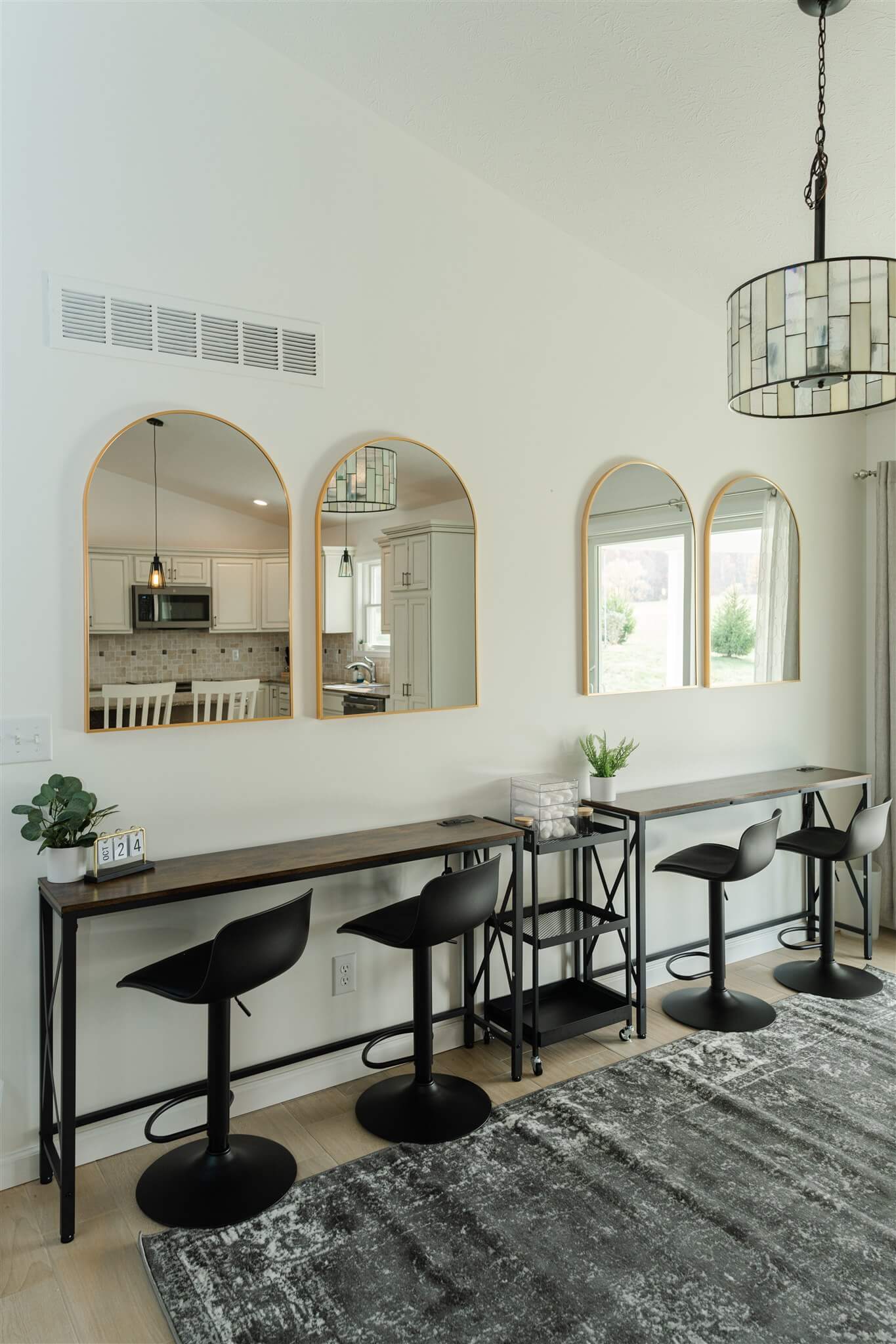 Row of Glam Suite beauty stations with stools and mirrors