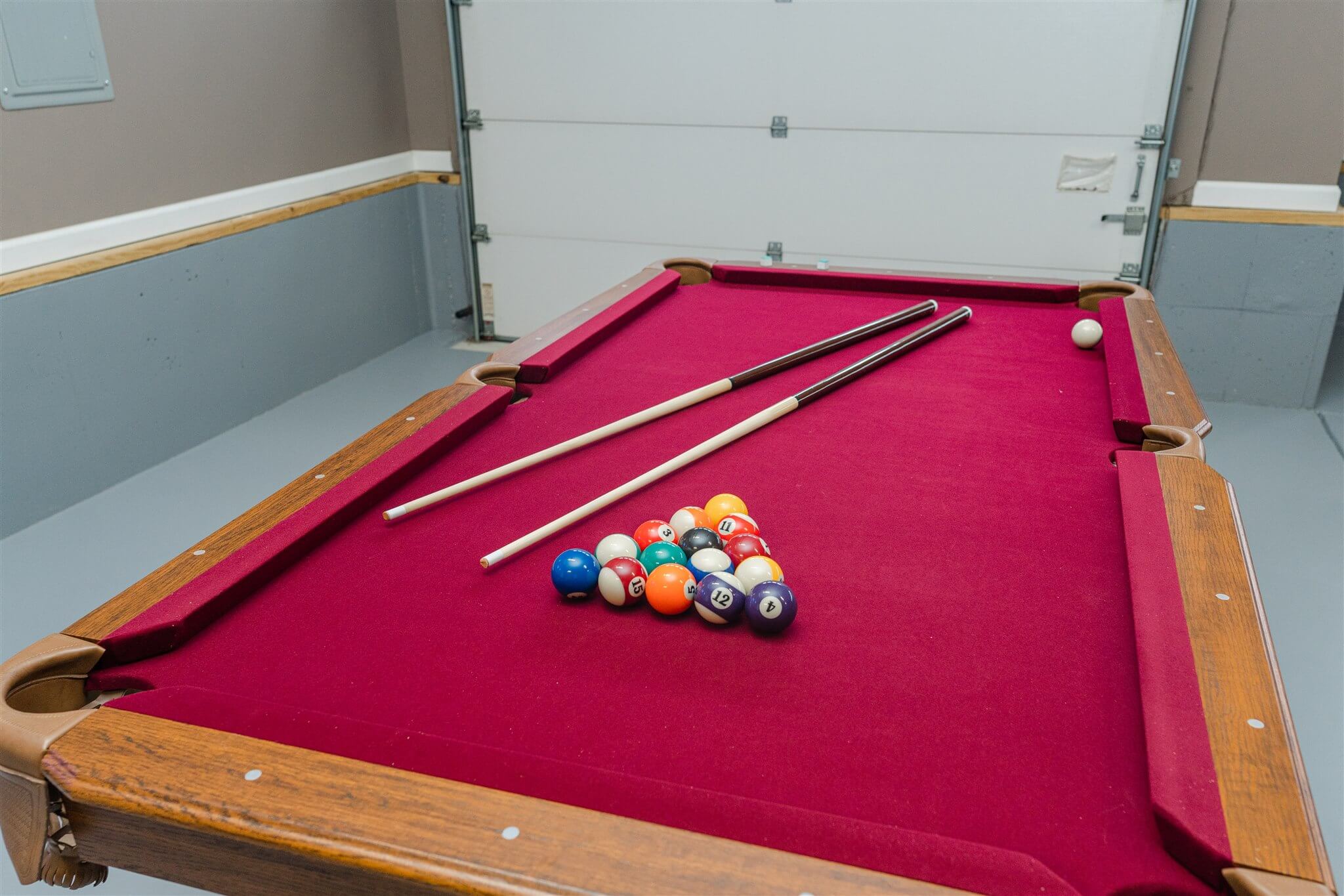 Pool table with cues and racked balls