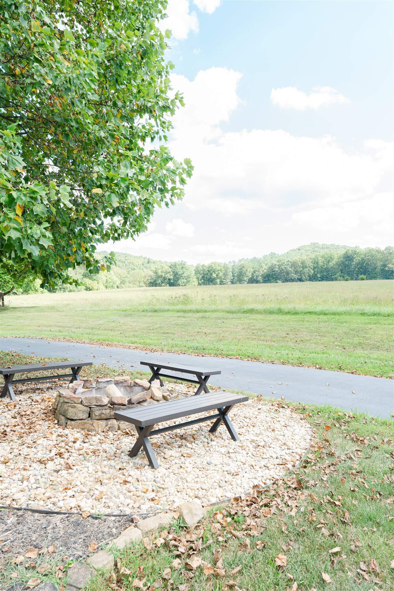 Circular fire pit area with benches and countryside view